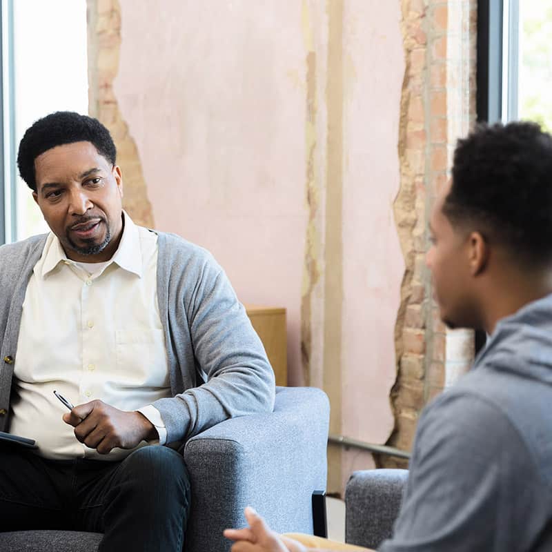 The therapist provides some feedback to his client about a difficult situation.